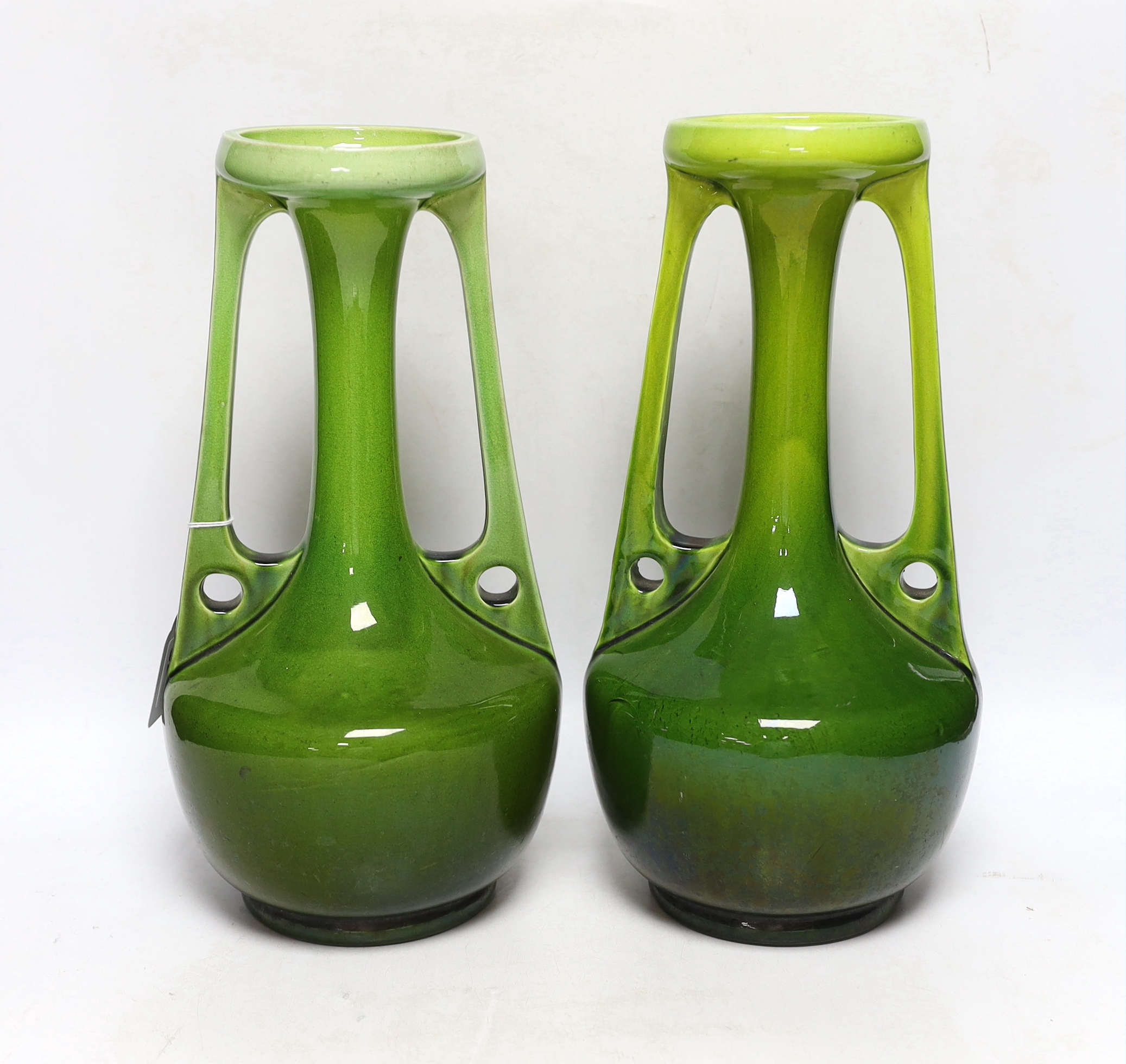 A pair of Bretby Arts and Crafts style vases, impressed model number 1565, circa 1900, 33cm high